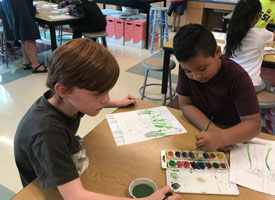  two students painting